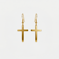 Boucles d'oreilles en forme de croix, dorées, sur fond blanc