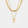 Collier croix double chaine, doré, sur fond blanc