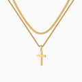 Collier croix double, doré, sur fond blanc