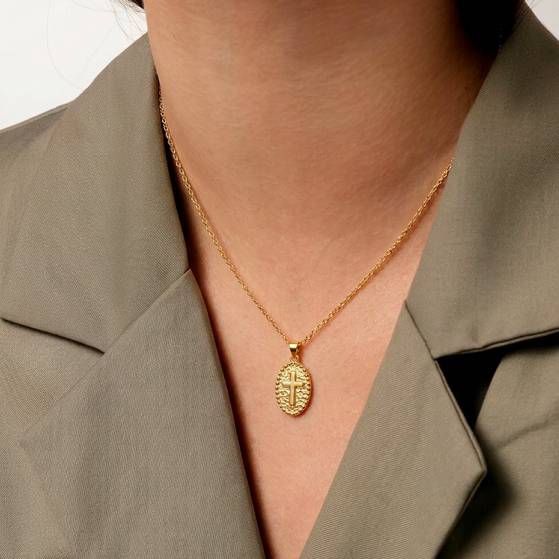 Collier médaille croix, porté au cou